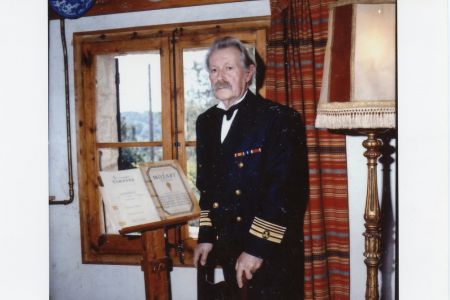 José Pérez del Río in machine chief uniform in front of a lectern with a music book