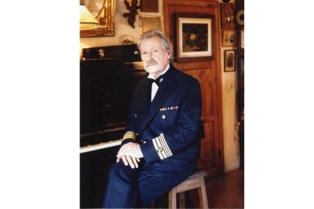 José Pérez del Río in machine chief uniform at his home sitting in front of his piano
